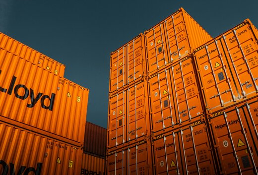 The pictures shows orange oversee-containers for trading and shipping.